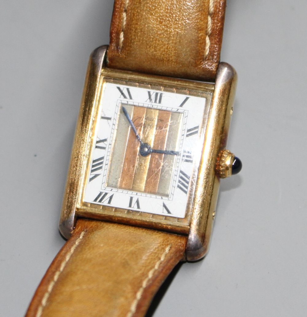A ladys 925 gilt Must de Cartier Vermeil Tank quartz wrist watch, on associated strap.